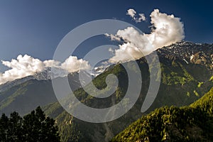 Moving clouds at high snow peak mountain plateau.