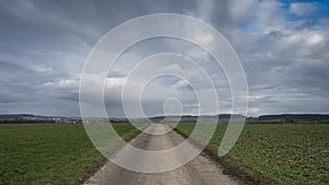 Moving clouds over a country road