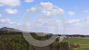 Moving cloudscape above rural landscape, aerial hyper lapse