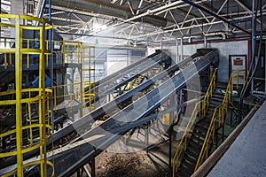 Moving conveyor transporter on Modern waste recycling processing plant. Separate and sorting garbage collection. Recycling and