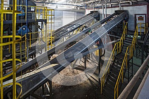 Moving conveyor transporter on Modern waste recycling processing plant. Separate and sorting garbage collection. Recycling and