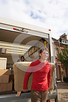 Moving Couple Unloading Sofa From Truck