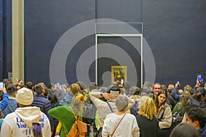 Moving crowd capturing selfie, wefie in front of Mona Lisa portrait by the Italian artist Leonardo da Vinci