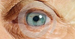 Moving eye, sight and vision of senior person eyeball. Health, medical eye exam and macro close up of blue eyes of a old