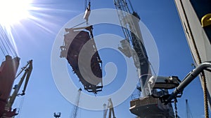 Moving freight railway car in the port by a port crane. Cargo li