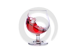 moving a glass of red wine on a white background