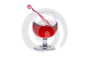 moving a glass of red wine on a white background