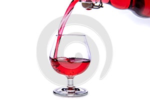 moving a glass of red wine on a white background