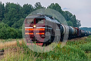 a moving goods train with many carriages in countryside