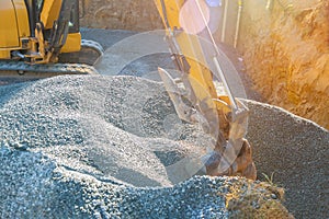 Moving gravel excavator in the construction works of a foundation of the house