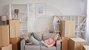 Moving happiness new home dreaming girl sofa boxes