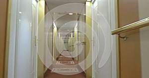 Moving in hotel corridor with light interior