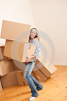 Moving house: Woman holding heavy carton box