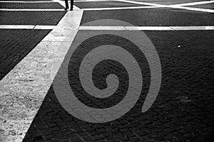 Moving legs on the geometric pattern of `Piazza del Campidoglio`, Rome, Italy