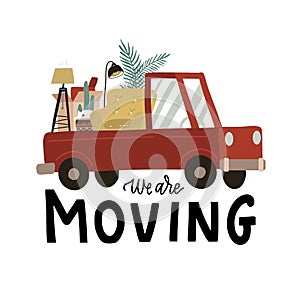 We are moving - lettering banner. Truck full of assorted furniture in cardboard boxes. Concept of moving to new house