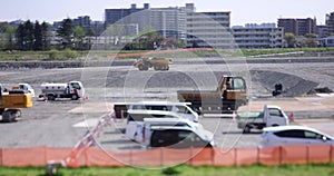 Moving miniature cranes at the under construction daytime tiltshift