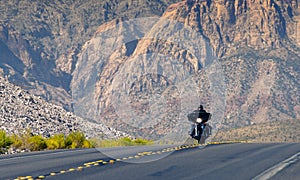 A moving motorcyclist in Red Rock Canyon, Nevada, USA