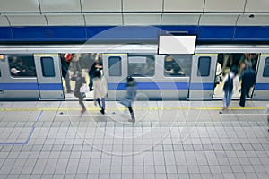 Moving people enter carriage at metro station