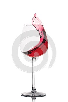 Moving red wine glass over a white background