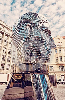 Moving statue of Franz Kafka in Prague, red filter