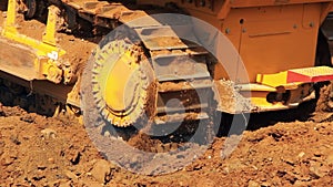 Moving steel caterpillars of bulldozer. Heavy machinery in mining industry