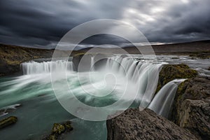 Long exposure of dark clouds over Godafoss Waterfall in Icealnd