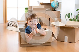 Moving to new apartment. Happy child in cardboard box.