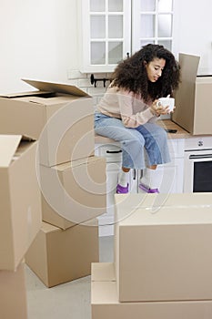 moving to new apartment relocation. happy young woman, packing boxes with personal belongings,