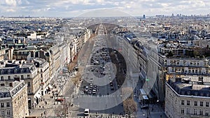 Moving traffic on Avenue des Champs-Elysees in Paris, France from above. Skyline with classical French buildings and