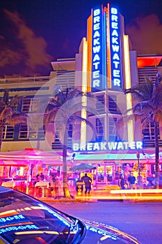 Moving traffic, Illuminated Breakwater hotel with car reflection