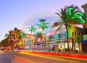 Moving traffic, Illuminated hotels and restaurants at sunset on Ocean Drive