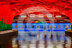 Moving train Stockholm metro or tunnelbana station Solna Centrum with fire like wall designs