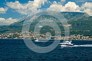 Moving white yachts on Boka Kotor bay near Herceg Novi, Montenegro