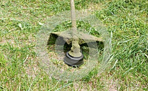 Mower close-up mowing green grass