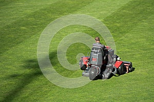 Mowing grass at the pitch of football stadium