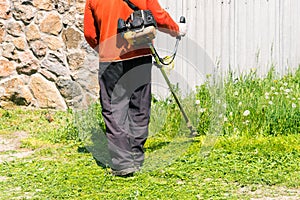 Mowing grass by hand lawn mower.