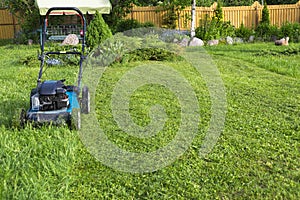 Mowing lawns Lawn mower on green grass mower grass equipment mowing gardener care work tool close up view sunny day