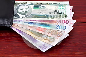 Mozambican money in the black wallet