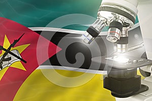 Mozambique science development concept - microscope on flag background. Research in clinical medicine or nanotechnology 3D