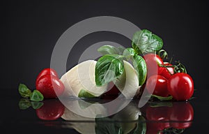 Mozarella with small tomatoes and basil .