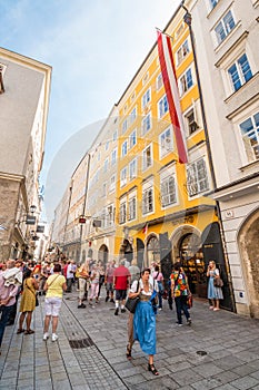 Mozart`s Birthplace house on busy popular shopping street Getreidegasse, Salzburg, Austria