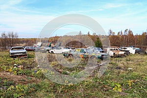 Old retro rusty abandoned cars junkyard. Vintage car outdoor