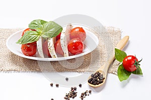Mozzareela, tomato and basil, on white background. .Mediterranean diet .and healthy food concept