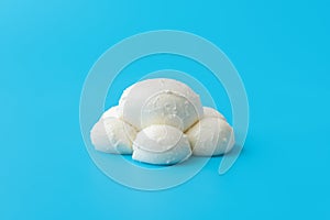 Mozzarella balls isolated on a blue background