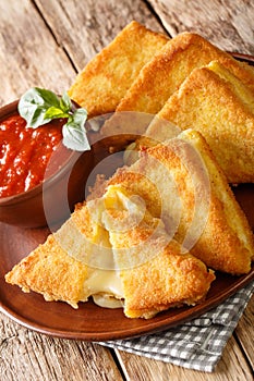 Mozzarella in Carrozza Fried Italian Sandwiches with sauce closeup in the plate. Vertical photo