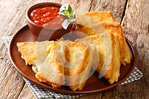 Mozzarella in Carrozza sandwich gets an extra dose of richness from a creamy egg bath and is coated in breadcrumbs for extra photo