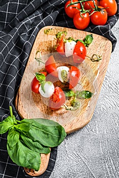 Mozzarella Cheese canape sandwiches on skewers, Caprese salad. gray background. top view