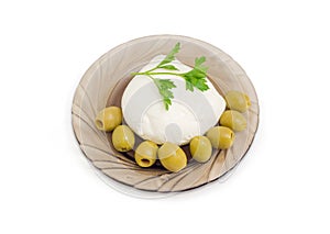 Mozzarella cheese with parsley and green olives on glass saucer