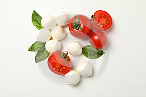 Mozzarella cheese, tomato and basil on white background