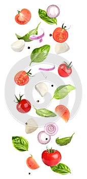 Mozzarella cheese, tomatoes, onion and basil leaves falling on background